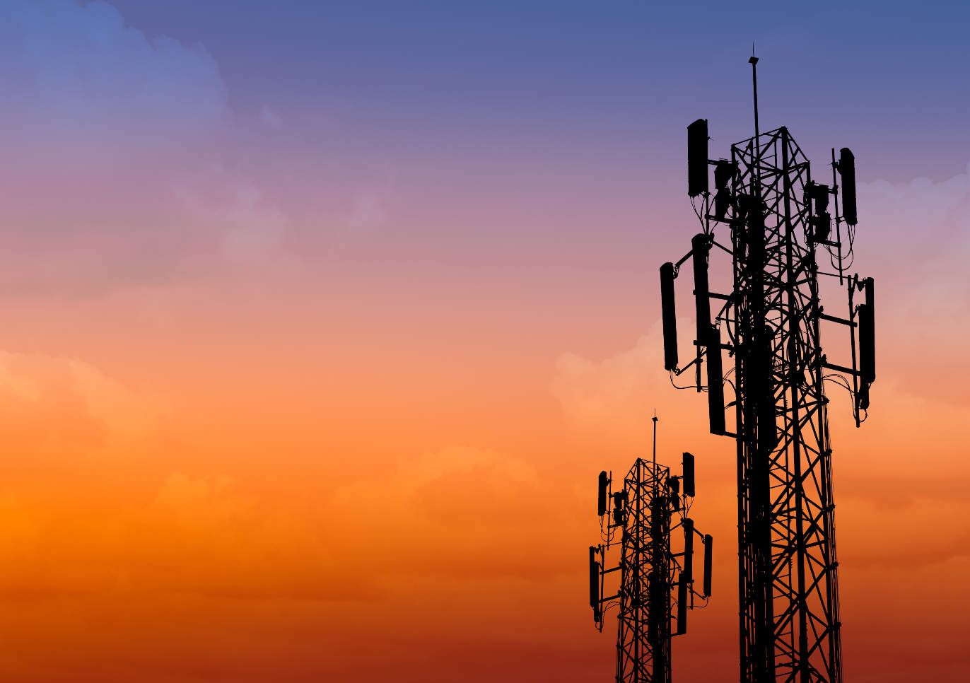 silhouette of communication tower with dusk sky with space for text
